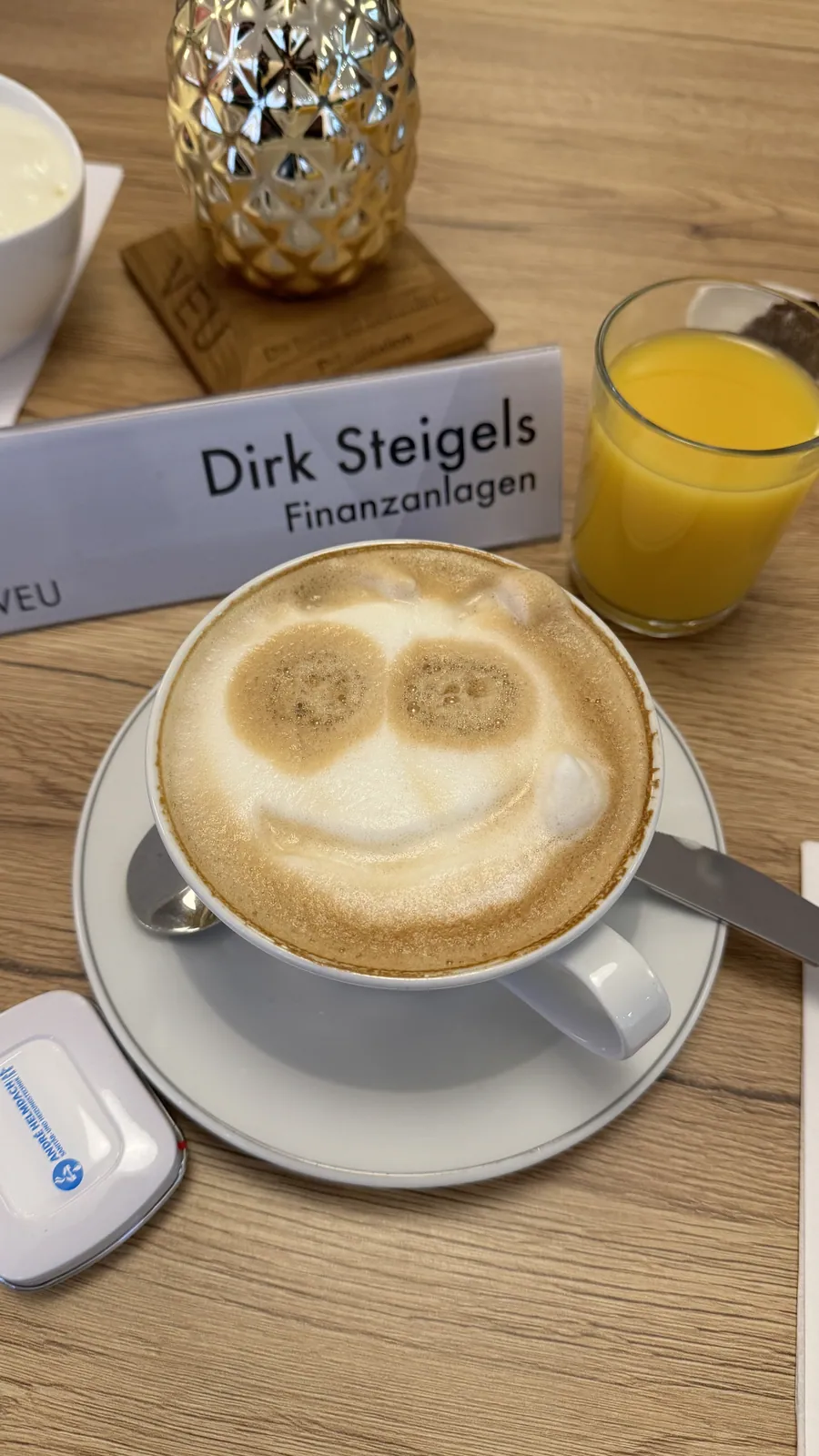 Namensschild von Dirk Steigels neben einer Tasse Kaffee